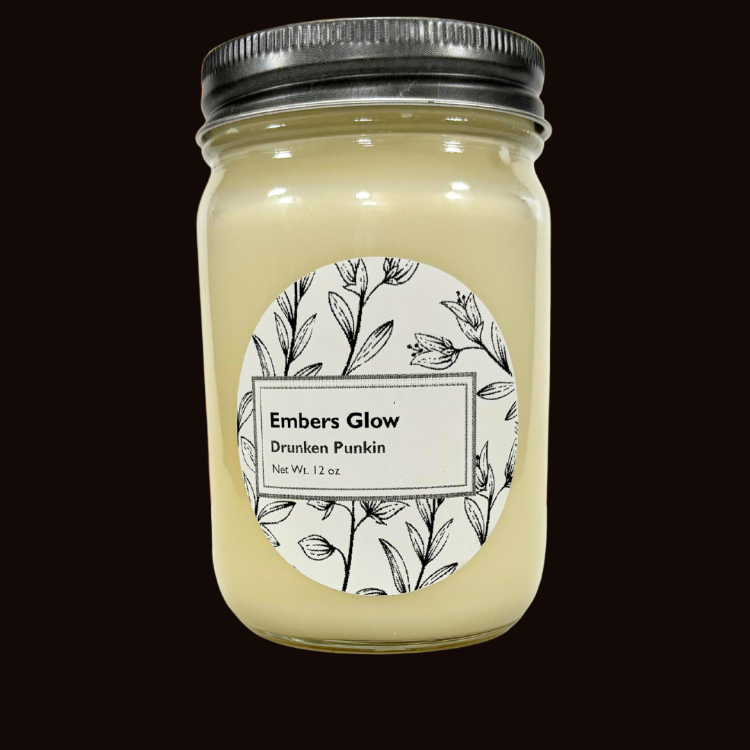 Glass jar candle with Drunken Punkin scent, featuring a blend of spiced pumpkin, vanilla, and bourbon, perfect for creating a cozy and playful fall atmosphere.