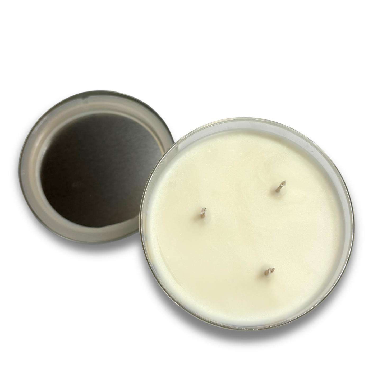 Top-down view of a hand-poured 17 oz three-wick soy wax candle from the Winter collection, with the lid placed to the side, showcasing the smooth wax surface and centered wicks.